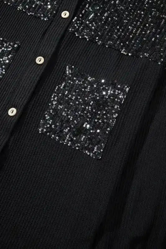 Close-up of sequin chest pocket on Black Corded Shacket Overshirt for women, showcasing glittery detail and textured material.