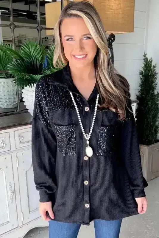 Front view of Women’s Black Sequin Patch Corded Shacket Overshirt featuring sparkly sequin chest pockets and oversized silhouette.