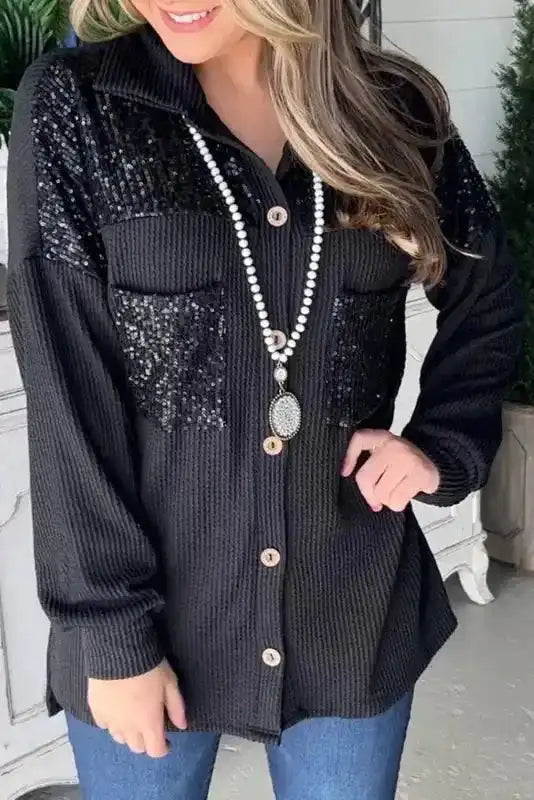 Women’s Black Sequin Patch Corded Shacket Overshirt with button front and chest pockets, styled casually with jeans for fall layering.