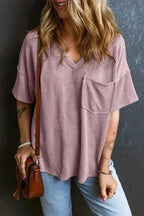 Front view of mauve pink corded V-neck T-shirt with chest pocket, styled casually with accessories and light denim for daily wear.