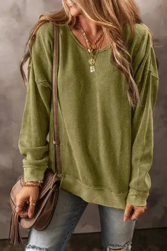 FashionFitz Jungle Green Textured Sweatshirt for women in a cozy ribbed fabric, styled with gold jewelry and a brown shoulder bag.