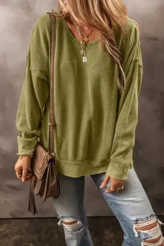 Solid color Jungle Green Textured Sweatshirt for women styled with ripped jeans and accessories, ideal for daily casual winter looks.