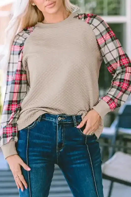 Close-up of quilted hooded dress with plaid sleeves, showing diamond quilt texture and casual fit for comfort and style.