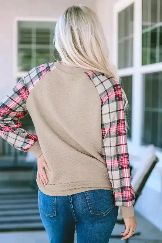 Back view of quilted hooded dress with plaid sleeves, showcasing casual H-line silhouette and textured fabric for daily wear.