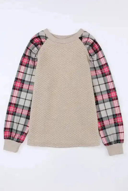 Flat lay of quilted hooded dress with red plaid sleeves, ideal for casual wear with a cozy and stylish design.