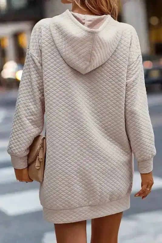 Back view of Quilted Hooded Dress - Kangaroo Pocket showing quilted texture and hood design in soft beige tone.