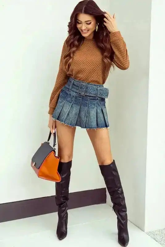 Full outfit featuring quilted hooded dress in camel brown with pleated denim mini skirt and knee-high black boots for a chic casual look.