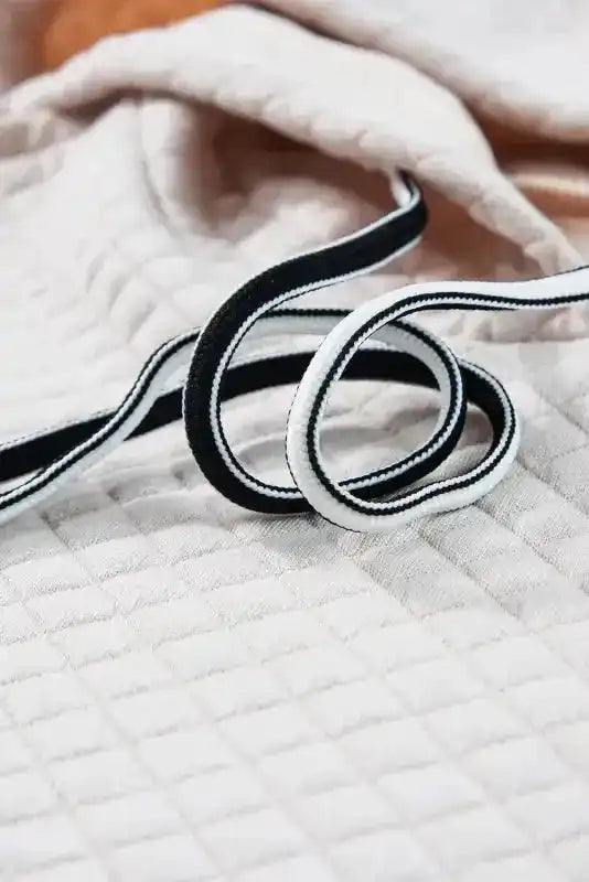 Detail of drawstring cords on Quilted Hooded Dress - Kangaroo Pocket, emphasizing quality and contrast design.