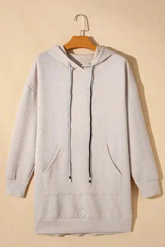 Quilted Hooded Dress - Kangaroo Pocket displayed on hanger, showcasing front pocket and drawstring hood.