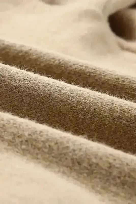 Close-up of khaki knit fabric texture from Khaki Aztec Knit Duster Cardigan showing soft and cozy material.
