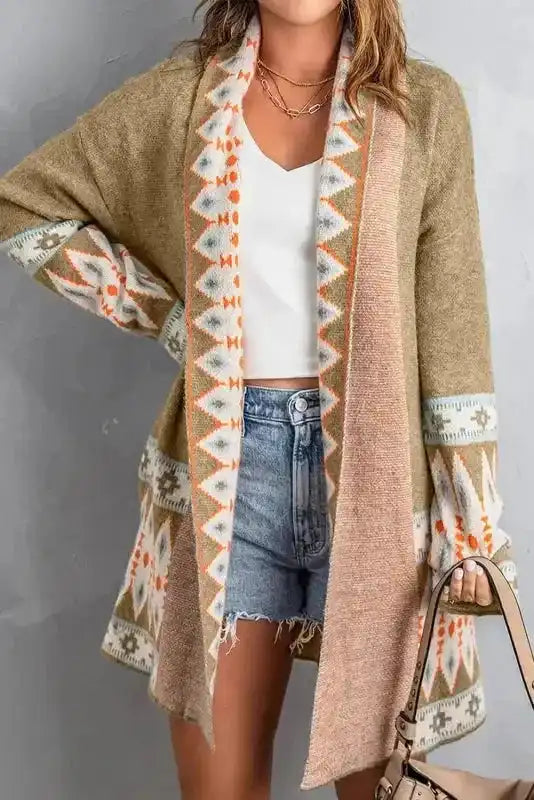Model wearing Khaki Aztec Knit Duster Cardigan with casual outfit, highlighting geometric Aztec patterns on cuffs and collar.