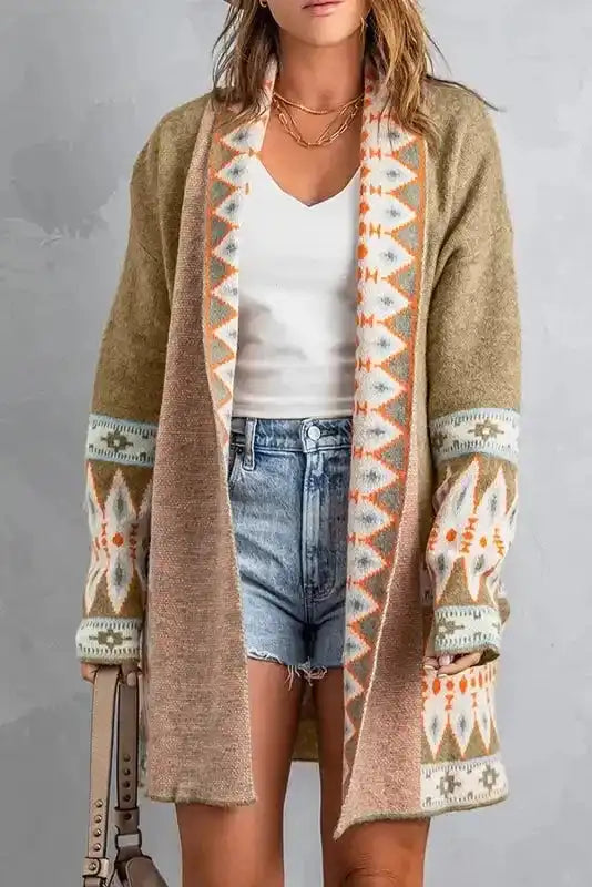 Khaki Aztec Knit Duster Cardigan styled with white top and denim shorts, featuring bold Aztec patterns on sleeves and trim.