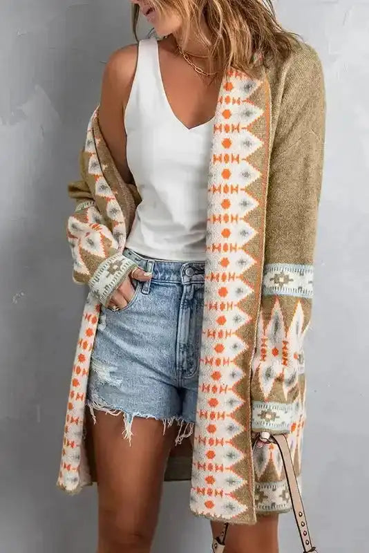 Open front Khaki Aztec Knit Duster Cardigan styled casually, featuring soft fabric and bold Aztec motifs in orange and white.