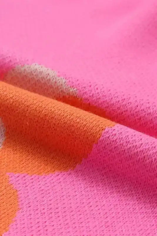 Fabric close-up of Khaki Floral Drop Shoulder Sweater, showing textured pink knit with orange floral detailing for cozy fall wear.