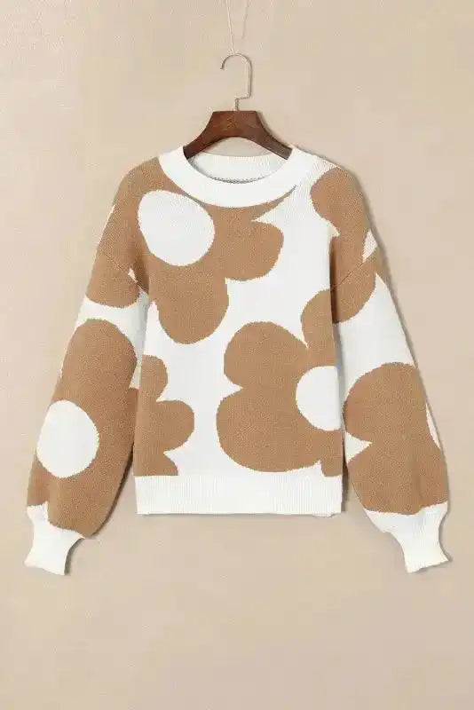 Flat lay of Khaki Floral Drop Shoulder Sweater on hanger, highlighting large floral print and ribbed cuffs for a cozy fit.