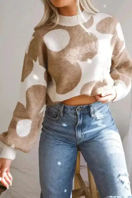 Versatile Khaki Floral Drop Shoulder Sweater cropped at waist, paired with high-rise jeans for a trendy fall look.