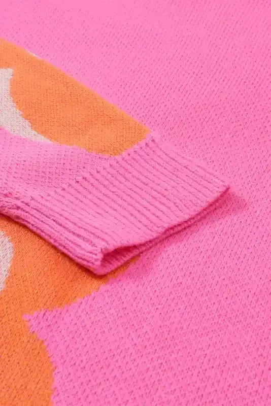 Detailed view of sleeve cuff on Khaki Floral Drop Shoulder Sweater, highlighting ribbed finish and vibrant floral knit pattern.