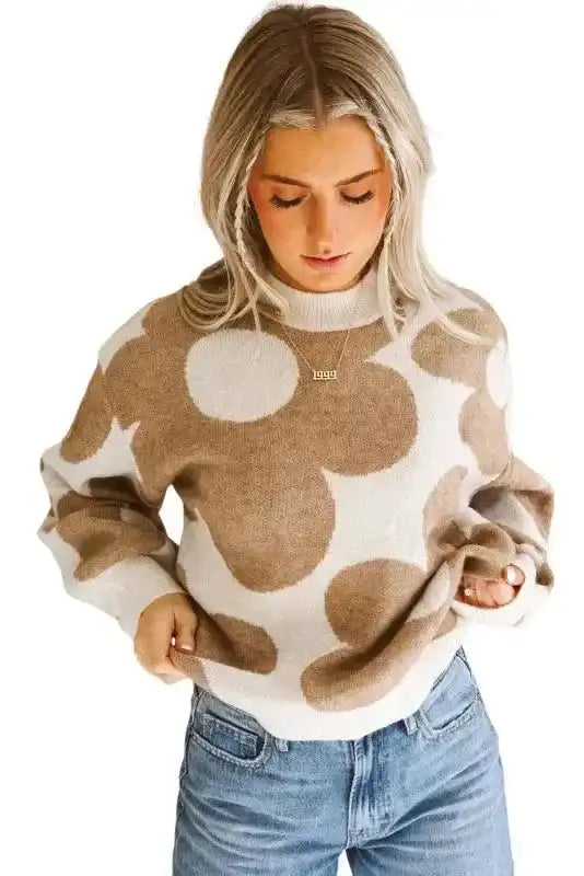 Model wearing Khaki Floral Drop Shoulder Sweater with blue jeans, showcasing casual fall fashion and floral design.