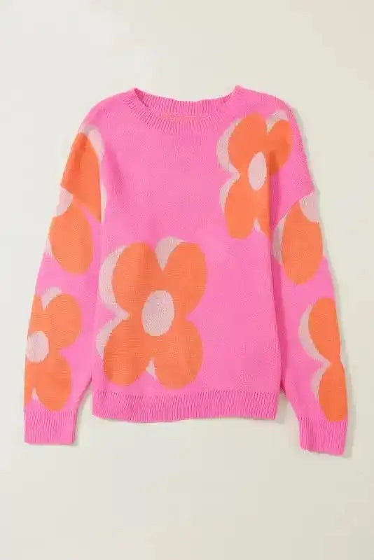 Flat lay of Khaki Floral Drop Shoulder Sweater in pink with orange floral print, highlighting relaxed silhouette and soft knit fabric.