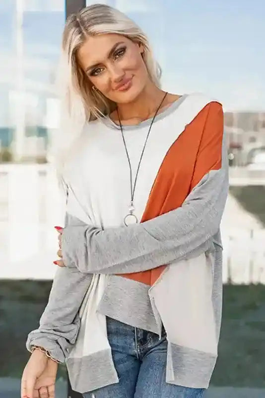Model wearing Khaki Colorblock Stitching Irregular Hem Long Sleeve Top with layered necklace and casual denim for a cozy fall look.