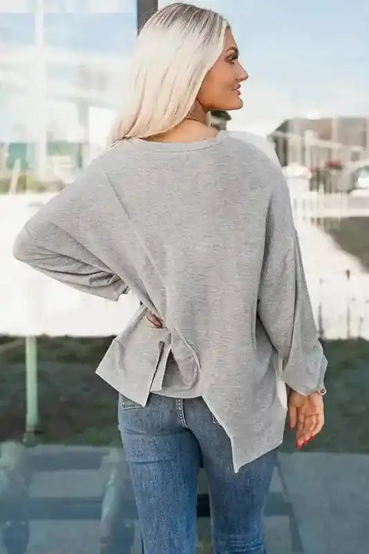 Back view of Khaki Colorblock Long Sleeve Top showing solid gray fabric and side slit detail for added comfort and style.