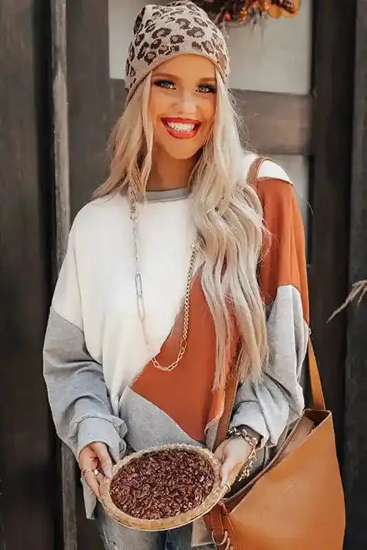 Trendy Khaki Colorblock Long Sleeve Top with asymmetrical hem, styled with accessories and a crossbody bag for a chic autumn outfit.