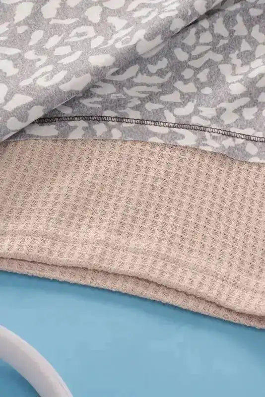 Hem detail of Khaki Plus Size Leopard Print Colorblock V Neck T Shirt showing ribbed fabric and stitching quality.