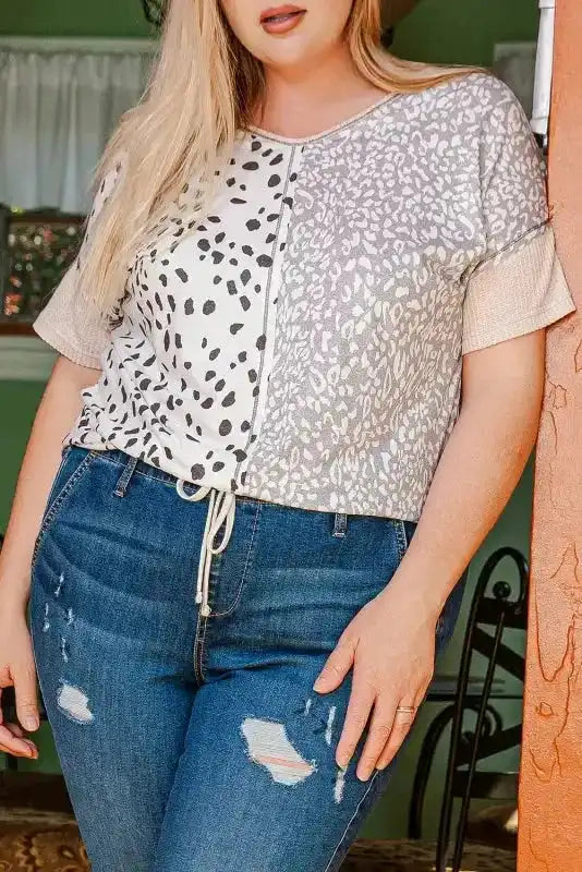 Front view of Khaki Plus Size Leopard Print Colorblock V Neck T Shirt styled with distressed jeans for a casual summer look.