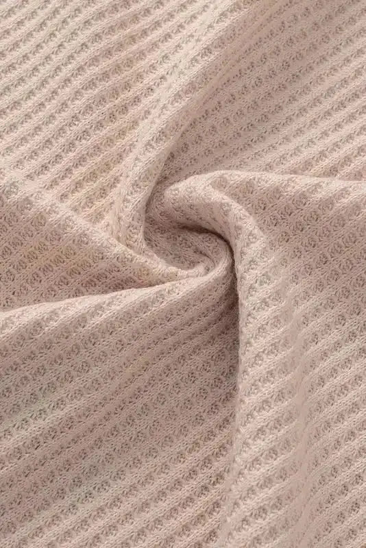 Close-up of ribbed khaki fabric used in the Khaki Plus Size Leopard Print Colorblock V Neck T Shirt showing texture detail.