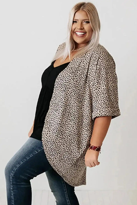 Plus size woman wearing a Khaki Leopard Print Cardigan from FashionFitz, styled with a black top and jeans. Lightweight summer cardigan with loose fit.