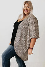 Plus size woman wearing a Khaki Leopard Print Cardigan from FashionFitz, styled with a black top and jeans. Lightweight summer cardigan with loose fit.