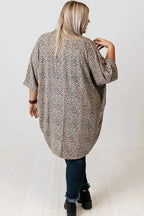 Back view of a plus size woman wearing a Khaki Leopard Print Cardigan from FashionFitz. Features loose fit and short sleeves, ideal for summer wear.