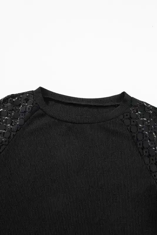 Close-up of neckline and lace shoulder of Black Lace Sleeve Textured Top, emphasizing elegant detailing and texture.