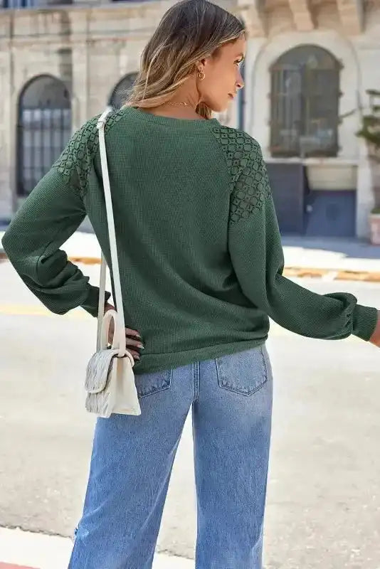 Rear view of Lace Sleeve Textured Top in green with intricate lace shoulders, worn with straight-leg jeans. Casual fall top for women by FashionFitz.