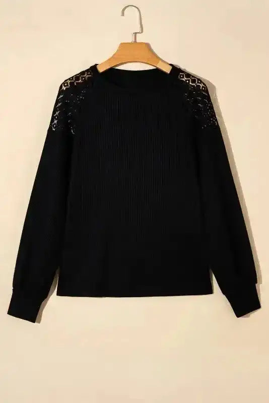 Black Lace Sleeve Textured Top on hanger, showcasing long sleeves and lace shoulder accents in a solid fall-ready design.