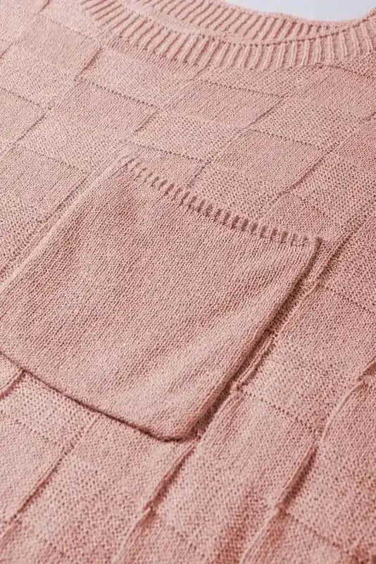 Close-up of chest pocket and knit texture on blush pink Lattice Short Sleeve Sweater by FashionFitz, showing fine detailing.