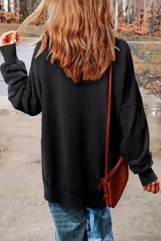 Back view of model in Leopard Patchwork Bishop Sleeve Sweatshirt | Unique & Trendy, showcasing relaxed fit and bishop sleeves.