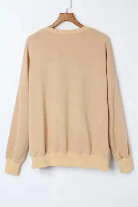 Back flat lay of beige bishop sleeve sweatshirt with ribbed hem and cuffs, perfect for casual daily wear in colder seasons.