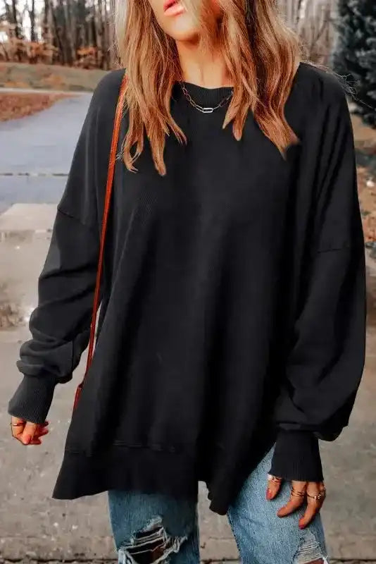 Front view of model wearing Leopard Patchwork Bishop Sleeve Sweatshirt | Unique & Trendy with ripped jeans for a casual winter look.