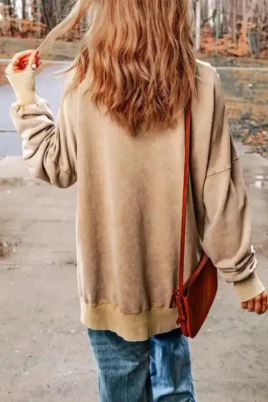Back view of beige bishop sleeve sweatshirt with ribbed hem and relaxed fit, ideal for casual winter wear and layering.
