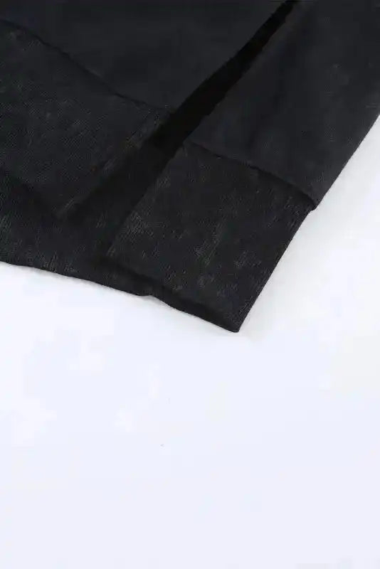 Detailed view of side slit hem on Leopard Patchwork Bishop Sleeve Sweatshirt | Unique & Trendy, emphasizing casual design.