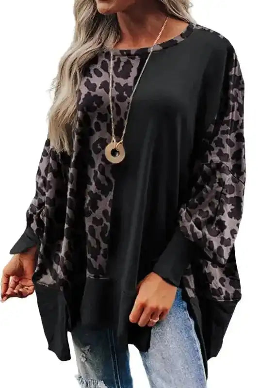 Front view of Leopard Patchwork Bishop Sleeve Sweatshirt with oversized fit, statement sleeves, and casual slit hem for a stylish western vibe.
