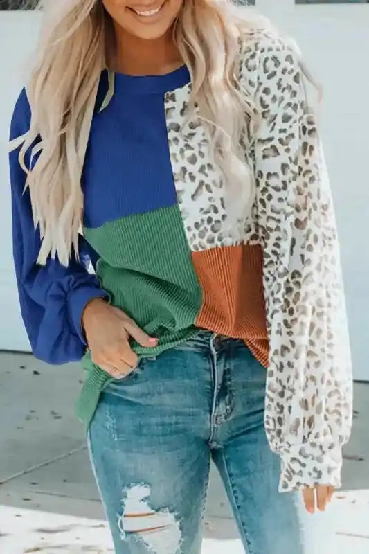 Model wearing blue, green, rust, and leopard print version of long sleeve tops leopard patchwork color block ribbed long with jeans.