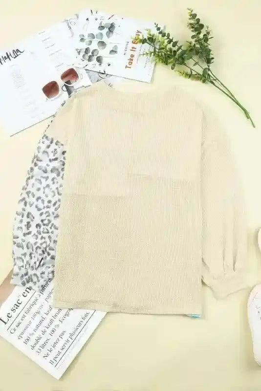 Back view of long sleeve tops leopard patchwork color block ribbed long showing solid beige ribbed knit and leopard print sleeve.