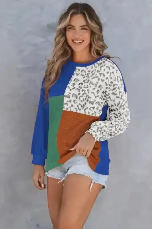 Model in shorts wearing blue, green, rust, and leopard print long sleeve tops leopard patchwork color block ribbed long for casual style.