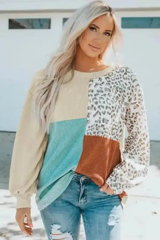 Chic leopard patchwork ribbed long sleeve top with crew neckline and relaxed fit, ideal for fall fashion collections.