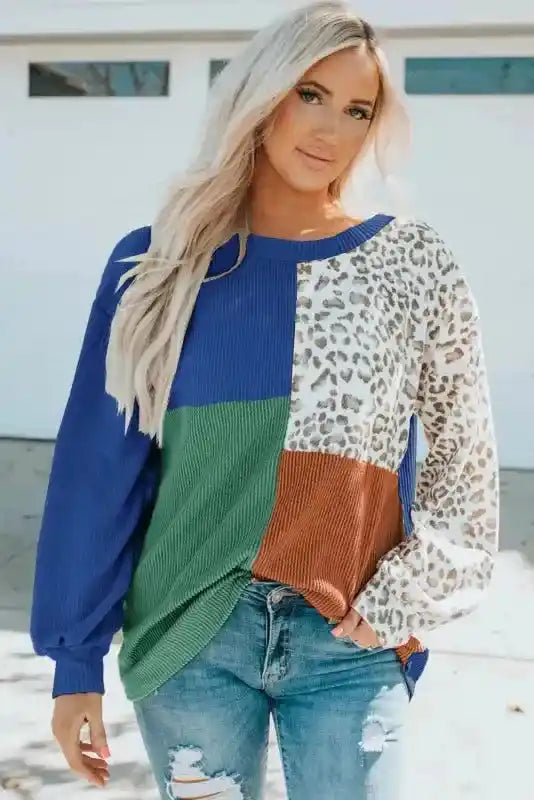Front view of model in blue, green, rust, and leopard print long sleeve tops leopard patchwork color block ribbed long styled for fall.