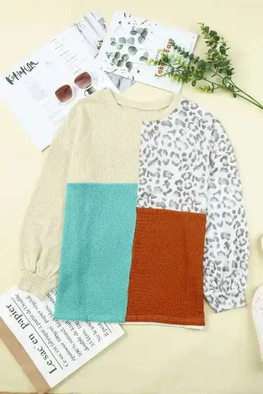 Long sleeve tops leopard patchwork color block ribbed long with beige, teal, rust, and leopard print panels laid flat on a beige background.