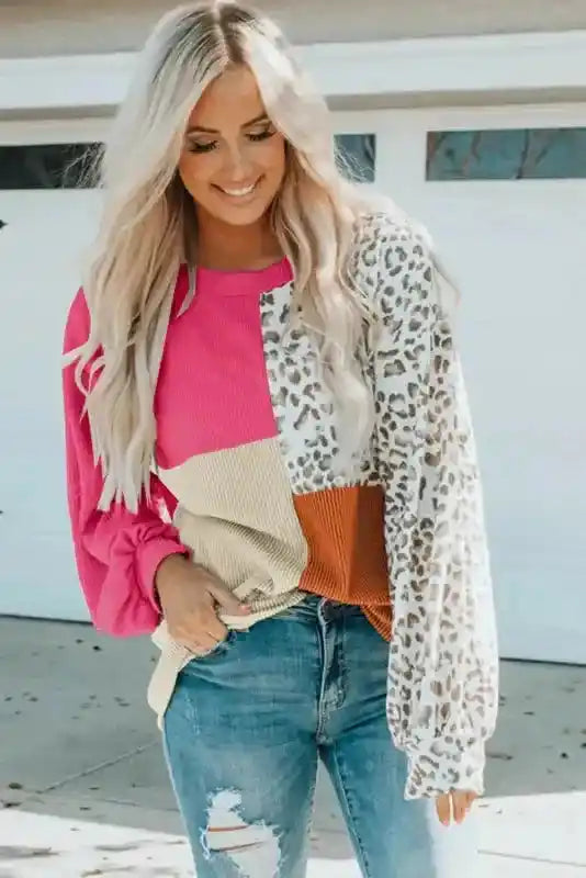 Trendy pink leopard patchwork ribbed long sleeve top with beige and rust color blocks, paired with jeans for a chic fall outfit.