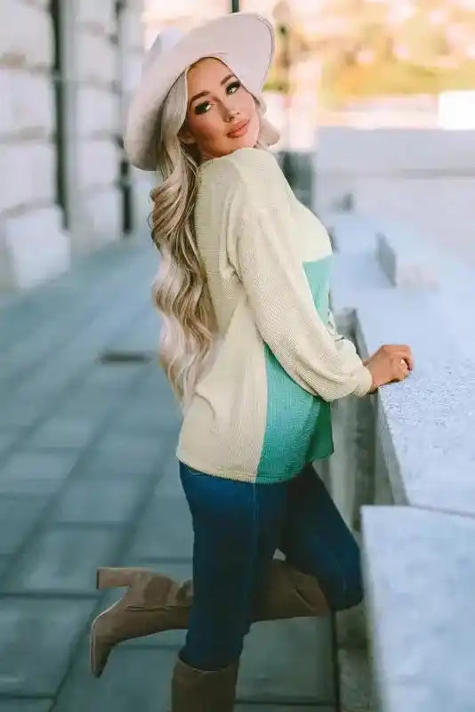 Southern Belle style ribbed long sleeve top with leopard print and color block, paired with knee-high boots and jeans.